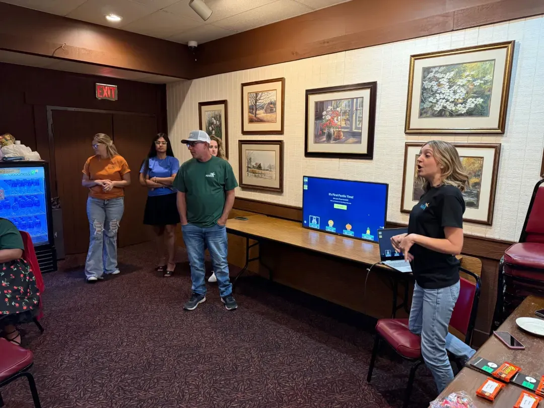 Alliance Pavers staff taking part in a trivia game during a team event.