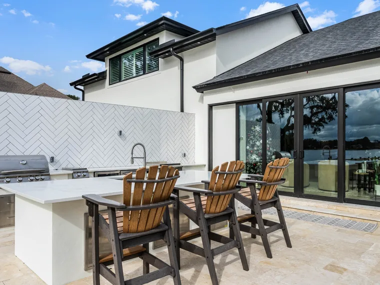 Custom outdoor kitchen and covered lounge area built by Alliance Pavers